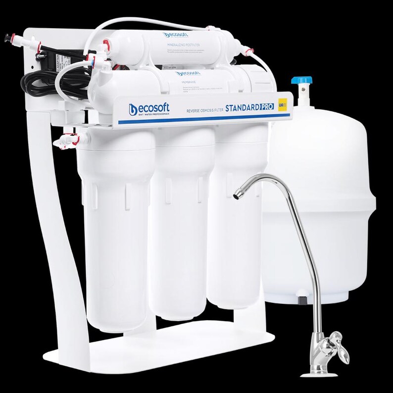 May include: A white water filtration system with a blue and yellow label that reads "STANDARD PRO". The system has four filters, a faucet, and a large white tank.
