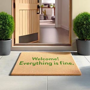 May include: A brown doormat with the text "Welcome! Everything is fine." in green lettering.