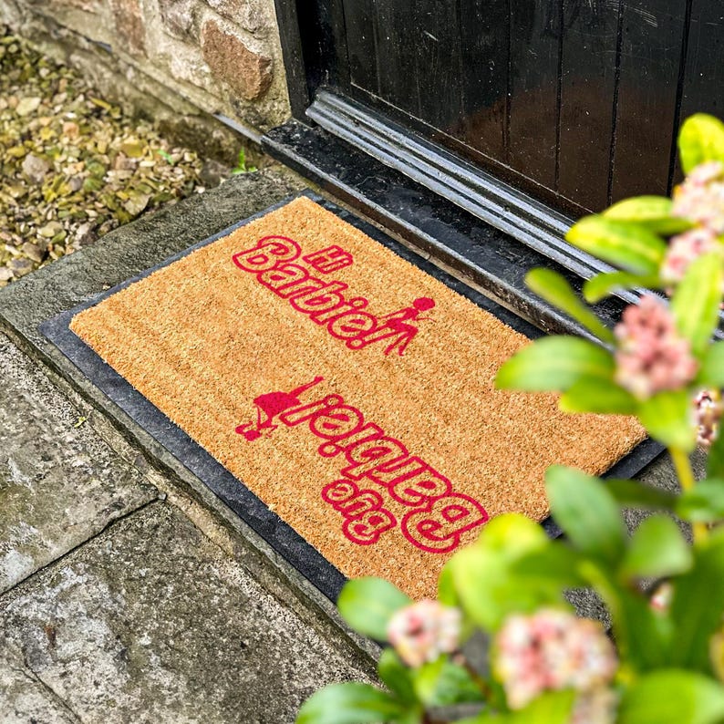 a door mat with the words welcome spring on it