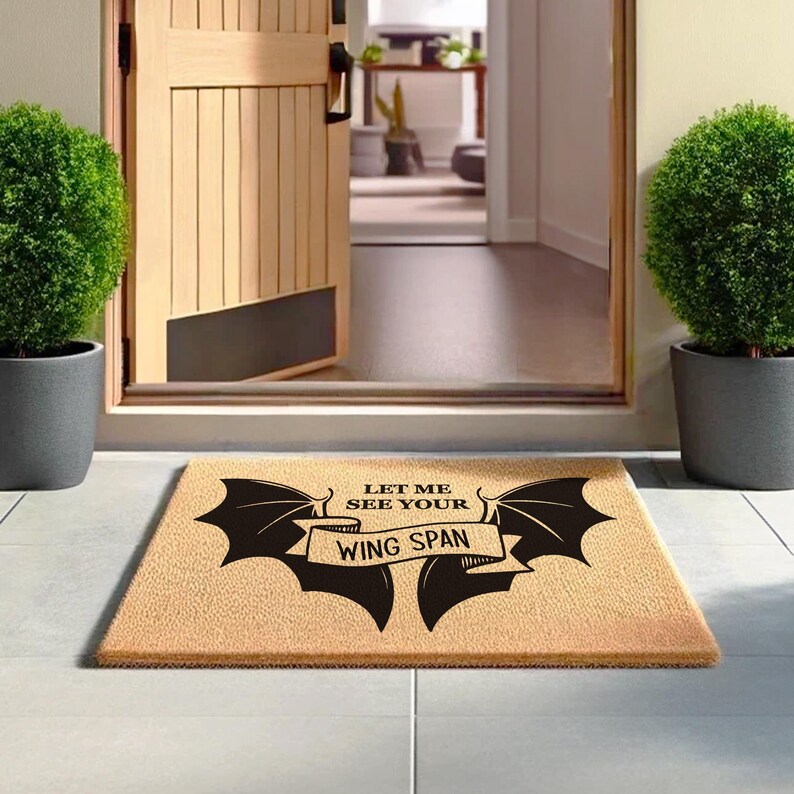 a door mat that says let me see your wing span