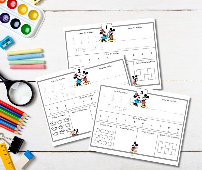 May include: Educational worksheets for learning numbers 1, 2, and 3. Each worksheet features tracing, writing, and counting exercises, with illustrations of Mickey and Minnie Mouse. Includes a magnifying glass, crayons, and watercolor paints.