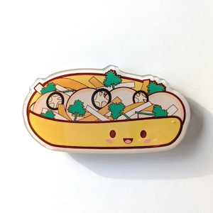 May include: A yellow cartoon sub sandwich with a smiling face. The sub is filled with white onions, green onions, mushrooms, and green peppers.