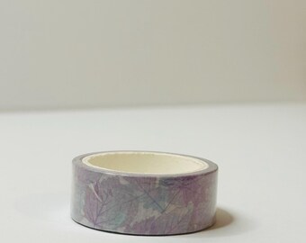 May include: A roll of washi tape with a purple and blue leaf pattern.