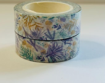 May include: Two rolls of washi tape with a floral pattern featuring purple, green, and gold leaves on a white background.