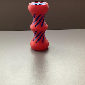 May include: A red and blue dog toy with a textured surface and a star-shaped design. The toy is made of rubber and is designed to be durable.