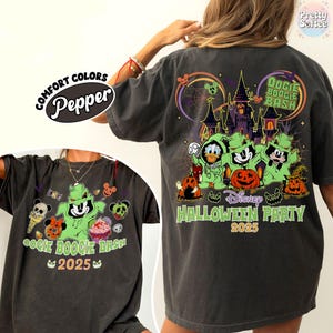 May include: Dark gray Comfort Colors t-shirt featuring a Halloween-themed graphic. The design includes the text "Oogie Boogie Bash 2025" and "Disney Halloween Party 2025" with cartoon characters and pumpkins. The shirt has a relaxed fit.