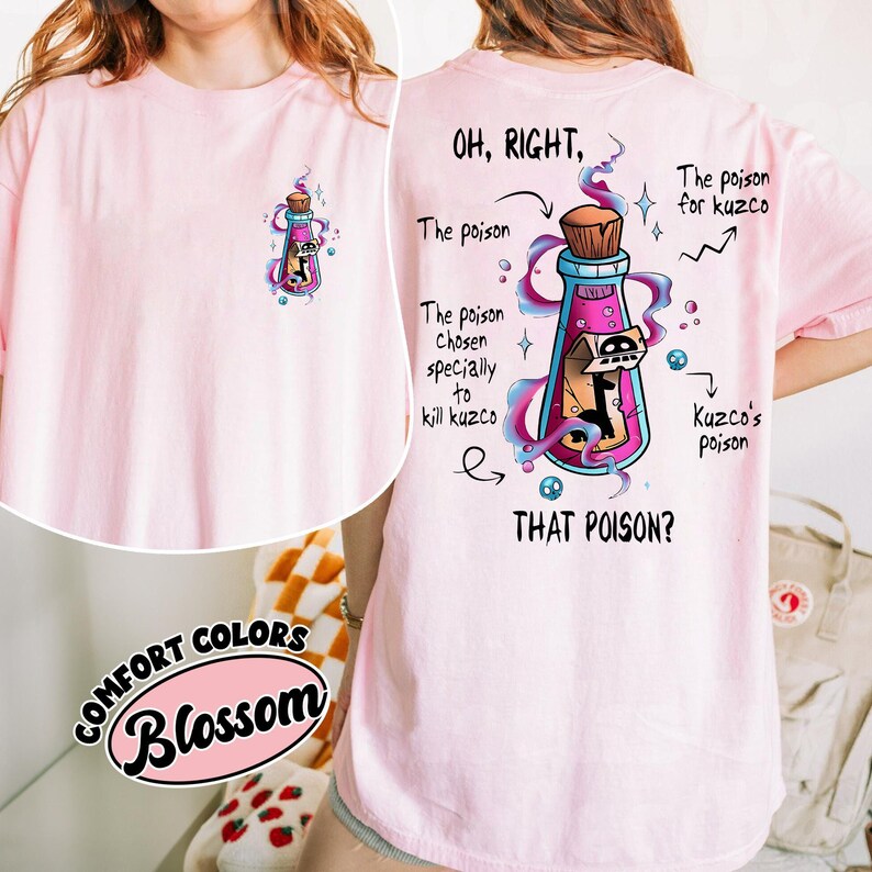 May include: A light pink t-shirt with a graphic of a potion bottle containing a cartoon character. The back of the shirt features the text "OH, RIGHT, THAT POISON?" with additional text and arrows pointing to the bottle and its contents.