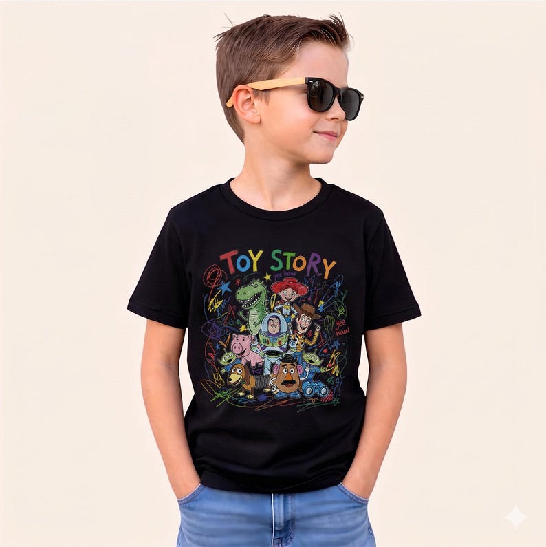May include: Black t-shirt featuring a colorful graphic of Toy Story characters with the words "TOY STORY" in rainbow colors. The design includes Woody, Buzz Lightyear, and other characters from the movie. The shirt is worn by a person wearing sunglasses.