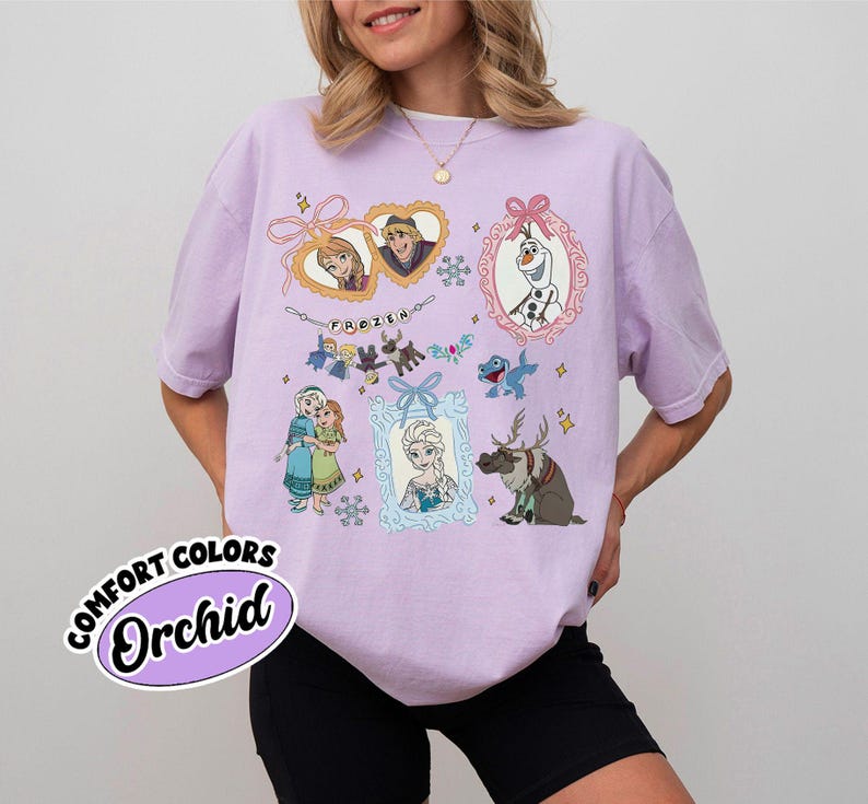 May include: A light purple t-shirt featuring various characters from the animated film "Frozen." The design includes framed portraits of Anna, Elsa, Kristoff, and Olaf, along with snowflakes and the word "Frozen." The shirt also has the words "Comfort Colors" and "Orchid" on it.