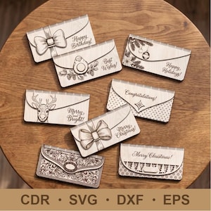 May include: A collection of seven rectangular wooden envelopes featuring laser-engraved designs including bows, a reindeer, holiday ornaments, and intricate floral patterns with text such as Happy Birthday, Best Wishes, and Merry Christmas.