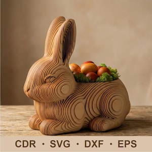 May include: A wooden rabbit-shaped decorative basket with a layered design. The basket is filled with colorful eggs and green moss. The bottom of the image displays the text "CDR • SVG • DXF • EPS".