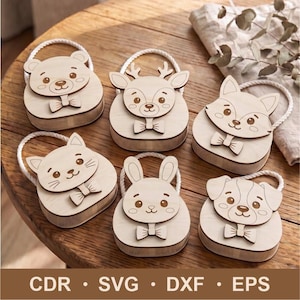 May include: Six light-colored wooden animal-shaped boxes with white rope handles. The set includes a bear, deer, fox, cat, rabbit, and dog, each featuring a bow tie detail. The text CDR, SVG, DXF, and EPS is printed at the bottom of the image.