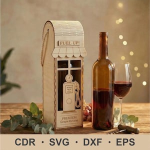 May include: A wooden wine bottle holder shaped like a vintage gas pump, with the words "FUEL UP!" and "PREMIUM Grape Octane". A brown wine bottle and a glass of red wine are next to the holder. A corkscrew and grapes are also visible.