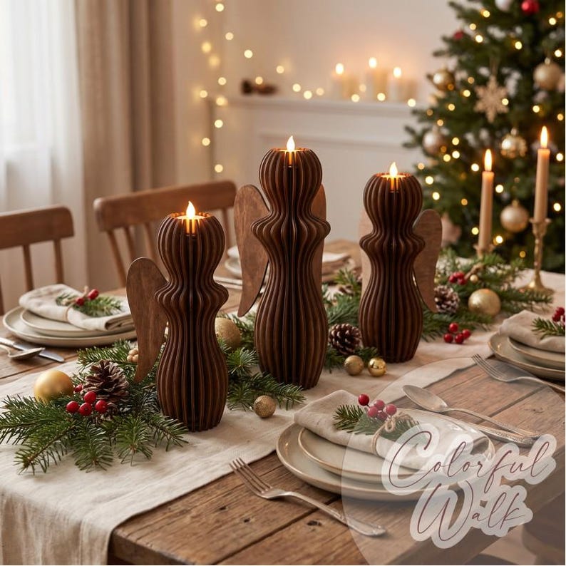 May include: Three dark brown wooden angel-shaped candle holders with vertical slats and glowing tea lights on top. The figures are arranged on a dining table decorated with pine branches, red berries, and gold ornaments for a holiday setting.