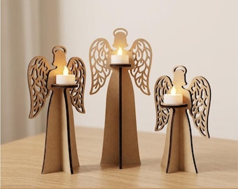 May include: Three light brown wooden angel-shaped candle holders of varying heights, each featuring intricate cut-out wing designs and a small white tea light candle. The text CDR, SVG, DXF, and EPS is printed at the bottom of the image.