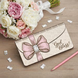 May include: A beige envelope with a pink bow and a sparkling gem in the center. The words "God Bless!" are written on the envelope. A bouquet of flowers and a pink pencil are also in the image.