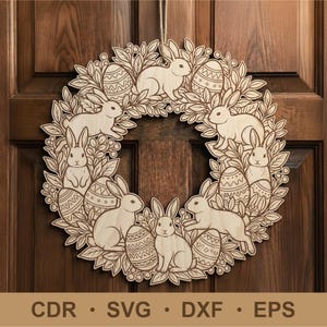 May include: Wooden Easter wreath with bunnies, Easter eggs, and leaves. The wreath is made of light-coloured wood and has laser-cut details. It hangs on a wooden door. The bottom of the image includes the text: CDR • SVG • DXF • EPS.