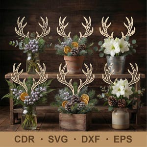 May include: Wooden deer antler decorations atop floral arrangements in various containers, including mason jars, a terracotta pot, and a metal bucket. The arrangements feature greenery, berries, and dried orange slices. The image includes the text "CDR • SVG • DXF • EPS".