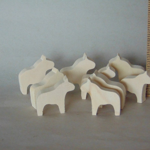 Nine tiny unfinished Dala horse cutouts