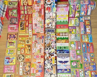 以下が含まれることがあります： 日本のテキストとイラストが描かれた、カラフルな装飾ステッカーのコレクション。ステッカーには、食べ物、動物、季節のテーマなど、さまざまなデザインが施されています。一部のステッカーには「Winter is coming」と「Angle Bell Rock」と書かれています。