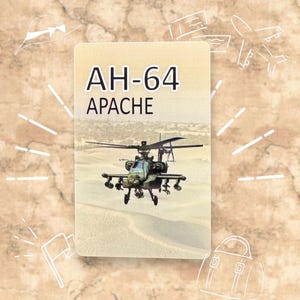May include: A card featuring an AH-64 Apache helicopter flying over a desert landscape. The text "AH-64 APACHE" is displayed in black at the top of the card. The background is a light beige color with white illustrations.