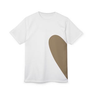 May include: White t-shirt with a brown heart shape design on the right side.