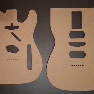 May include: A white ceramic mug with a black handle and the text "But First, Coffee" in a bold, black font. The mug is sitting on a wooden surface. The mug is approximately 4 inches tall.