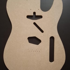 May include: A light brown, unfinished guitar body, cut from a wood composite material. The body features cutouts for the neck, pickups, and other hardware. The design is a classic electric guitar shape, ready for customization.