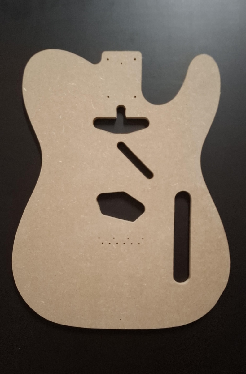May include: A light brown, unfinished guitar body, cut from a wood composite material. The body features cutouts for the neck, pickups, and other hardware. The design is a classic electric guitar shape, ready for customization.