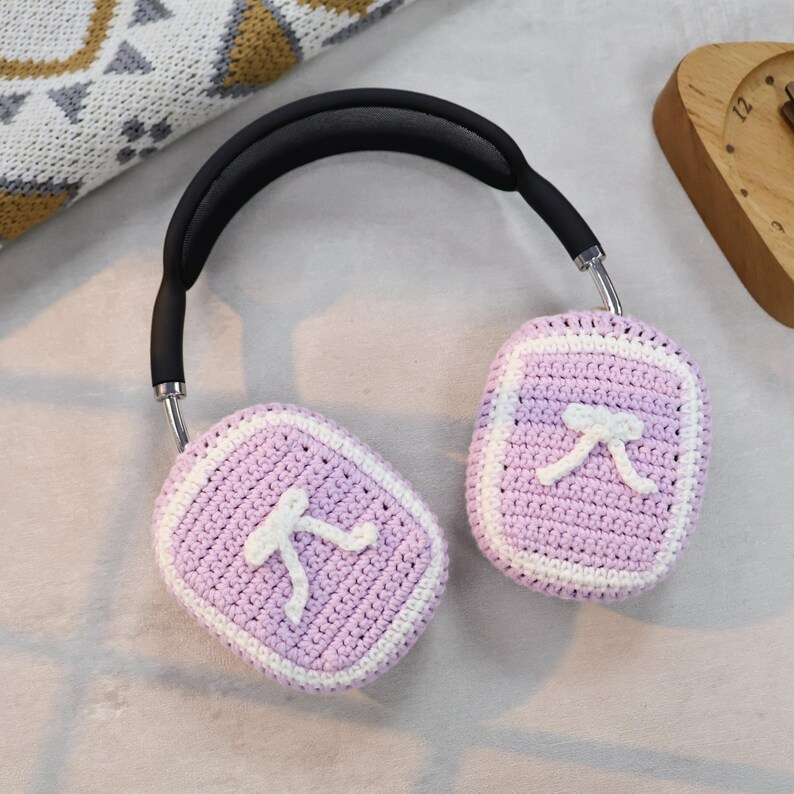 May include: Purple crocheted headphone covers with a white pi symbol on each cover.