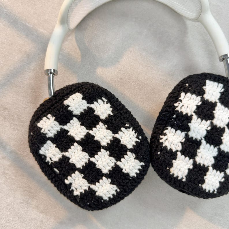 May include: White headphones with black and white checkered crochet earmuffs.