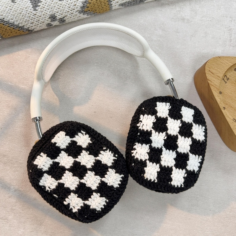 May include: White headphones with black and white checkered crochet ear covers.