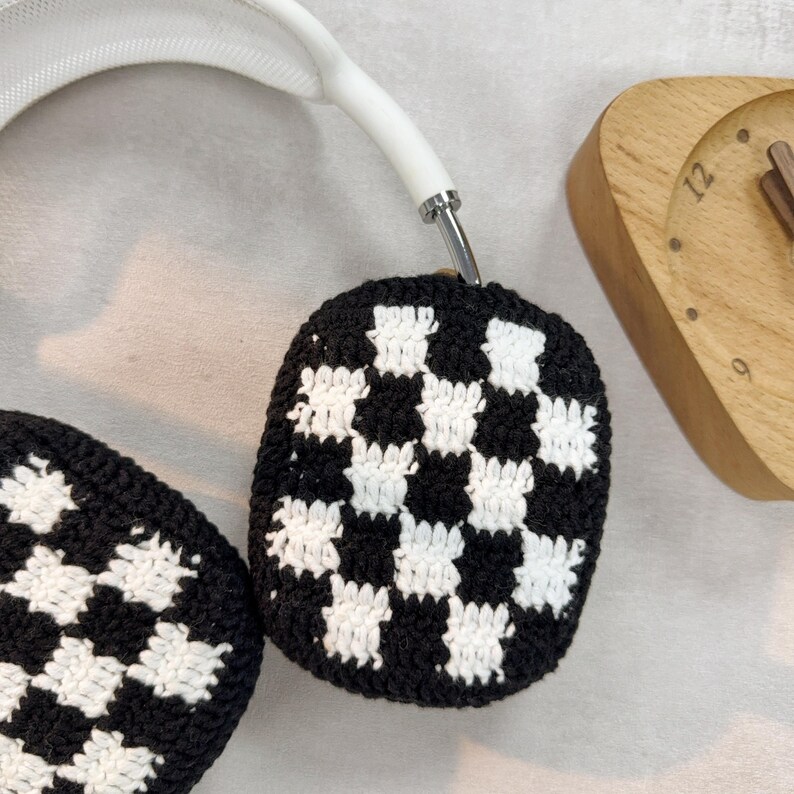 May include: White headphones with black and white checkered crochet ear covers.