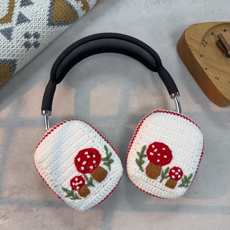 May include: White crocheted headphone covers with red and white mushroom embroidery.