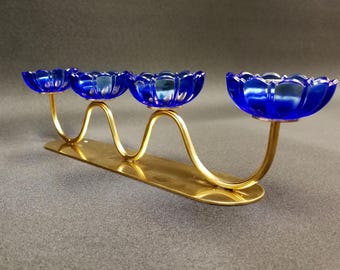 Beautiful 4-armed brass candle holder with Blue glass flowers. Designed by Gunnar Ander for Ystad Metall. Sweden, 1960