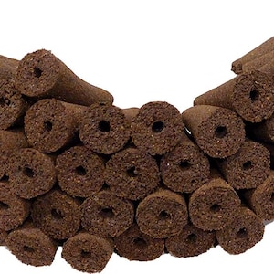 May include: A close-up of a large pile of brown, cone-shaped incense sticks. The incense sticks are arranged in a semi-circle shape.