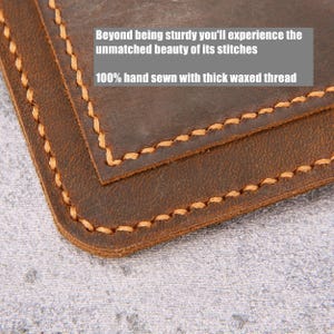 May include: A dark brown leather item with rounded corners and thick, light-colored waxed thread stitching along the edges. The text on the image reads: Beyond being sturdy you'll experience the unmatched beauty of its stitches 100% hand sewn with thick waxed thread.