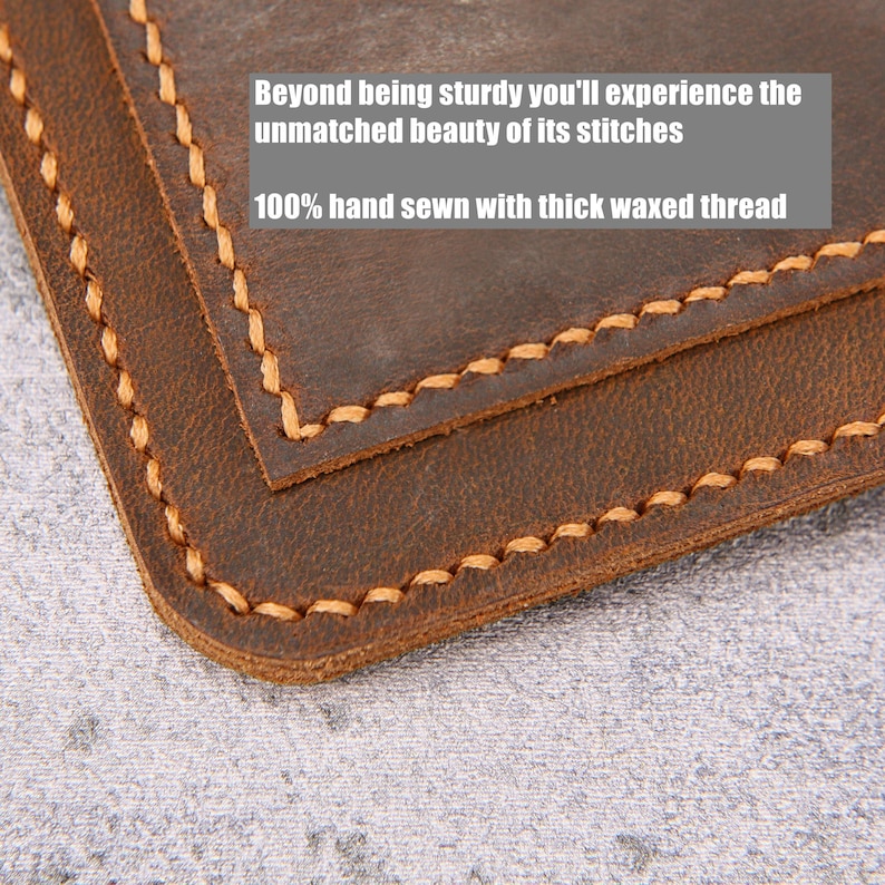 May include: A dark brown leather item with rounded corners and thick, light-colored waxed thread stitching along the edges. The text on the image reads: Beyond being sturdy you'll experience the unmatched beauty of its stitches 100% hand sewn with thick waxed thread.