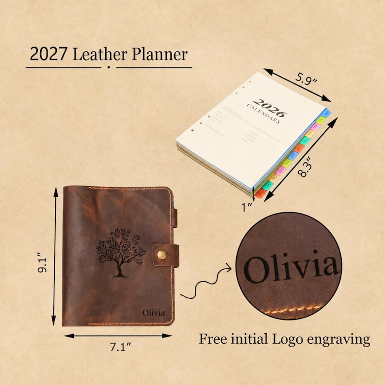 May include: A brown leather planner with a tree engraving and the name Olivia, measuring 9.1 inches by 7.1 inches. It includes a 2026 calendar insert measuring 8.3 inches by 5.9 inches by 1 inch, featuring colorful tabbed dividers and text.