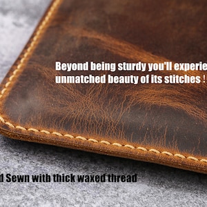 May include: Close-up of a brown leather pouch with a stitched edge. The text "Beyond being sturdy you'll experience the unmatched beauty of its stitches! 100% Hand Sewn with thick waxed thread" is visible.