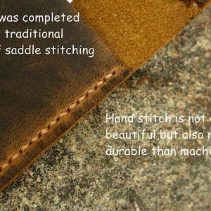 May include: Close-up of brown leather with a hand-stitched seam. The text reads "Every stitch was completed by hand using traditional techniques of saddle stitching. Hand stitch is not only beautiful, but also more durable than machine stitch."