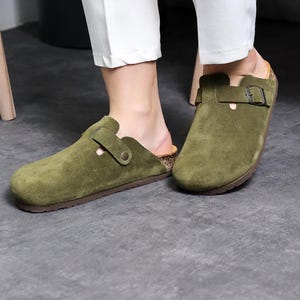 Puede incluir: Un par de zapatos de piel verde oliva con cierre de hebilla y plantilla de corcho.