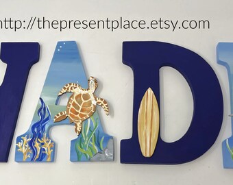 Wooden letters with a surf board, a turtle, a palm tree and two sharks