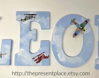 letters with blue skies and airplanes