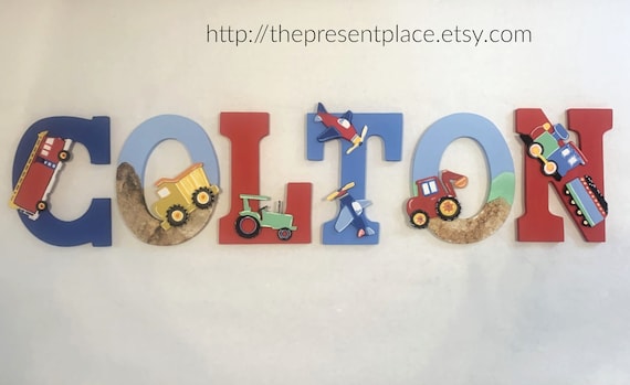 boys wooden letters with a firetruck, airplanes, a train, tractor, dump truck and excavator