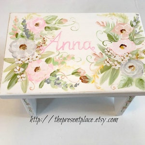 pink and grey flowers on a stepstool