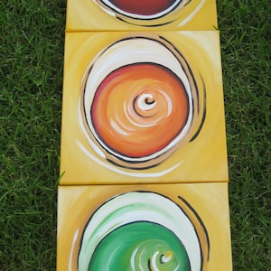 A large original traffic light painting on three 12"x 12" canvases with bright colors. A light bright painting for boys room or play room