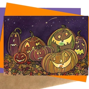 May include: A Halloween-themed greeting card featuring a group of carved pumpkins with various expressions. The pumpkins are set against a dark purple night sky with stars and a shooting star, resting on a bed of colorful autumn leaves.