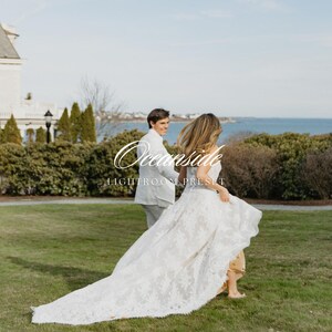 May include: A couple runs across a grassy lawn near the ocean. The person in the foreground wears a white lace wedding dress with a long train. The other person wears a light gray suit. The text "Oceanside Lightroom Preset" is in the image.