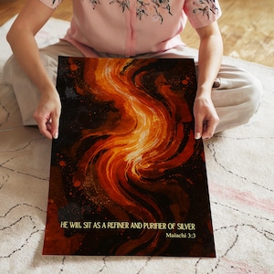May include: Abstract art print with a fiery, swirling design in shades of orange, red, and black. The artwork features the text "HE WILL SIT AS A REFINER AND PURIFIER OF SILVER Malachi 3:3" in gold lettering.